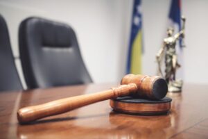 Courtroom desk with legal documents and gavel representing a Del Mar criminal defense attorney preparing for court