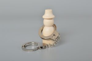 Figurine of a person wearing handcuffs, representing house arrest and criminal sentencing explained by an Escondido criminal defense attorney.