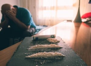 Illegal drugs displayed on a table, illustrating fentanyl-related criminal charges explained by a Solana Beach criminal defense attorney.