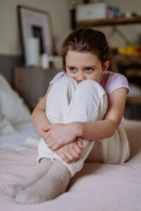 Young person sitting alone in a distressed setting, illustrating sensitive criminal cases discussed by a San Diego criminal defense lawyer.