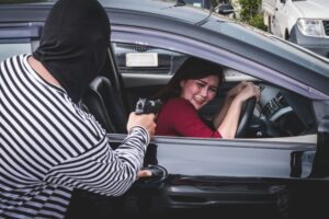 Illustration of a carjacking incident involving a firearm, representing charges explained by a Chula Vista criminal defense lawyer.