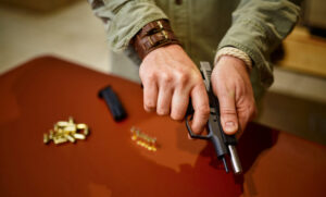 Person holding a handgun to illustrate California loaded firearm laws explained by a San Diego criminal defense attorney.
