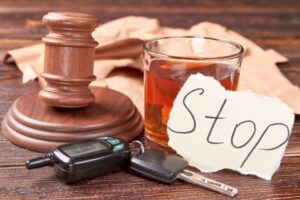 Alcohol glass beside a gravel road symbolizing a California DUI case explained by a San Diego criminal defense attorney.