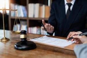 San Diego criminal defense attorney sitting at a desk explaining plea deal options to a client during a legal consultation.
