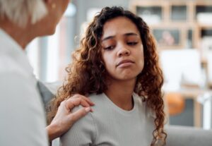 Parent comforting a worried teenager after a minor in possession incident with guidance from a Hillcrest criminal defense attorney