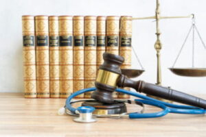 Law books and a judge's gavel representing California healthcare fraud laws and the role of a Medi Cal Fraud Defense Attorney in San Diego.