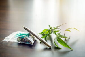 Marijuana products and cannabis leaves displayed on a table, highlighting drug-related offenses discussed by a marijuana Chula Vista criminal defense lawyer.