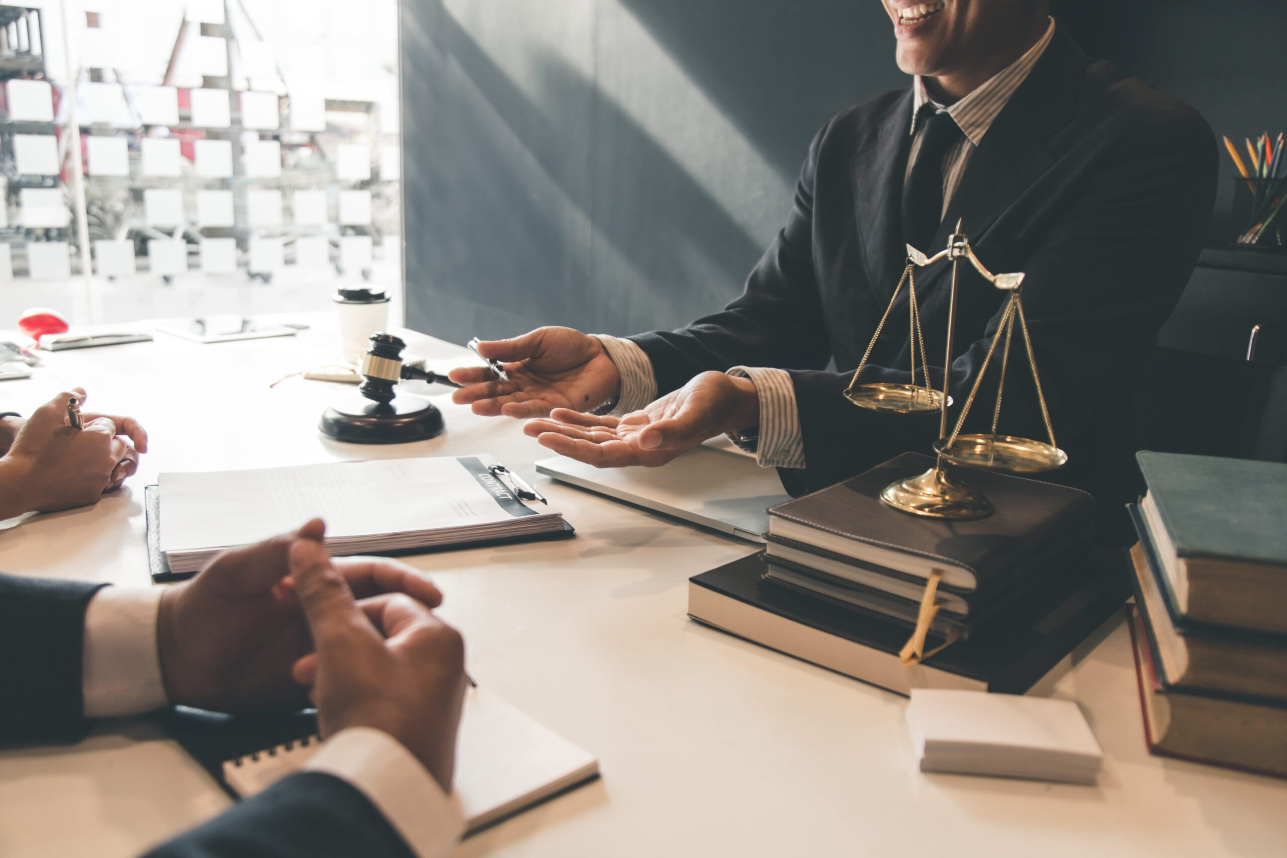 San Diego property crimes defense attorney and lawyers discussing a case in a corporate office setting