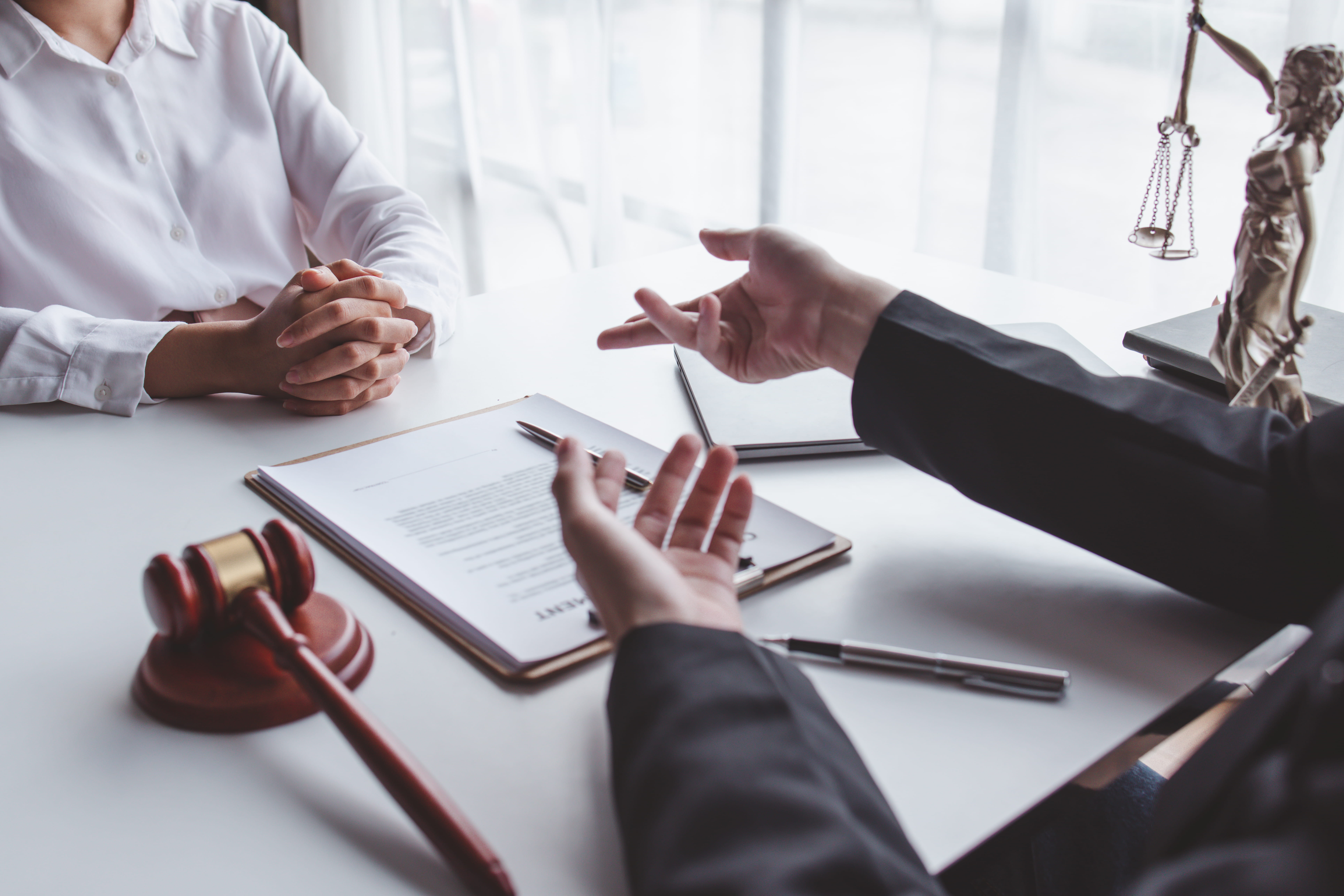 San Diego criminal defense attorney consulting with a client in a professional law office discussing legal defense strategy