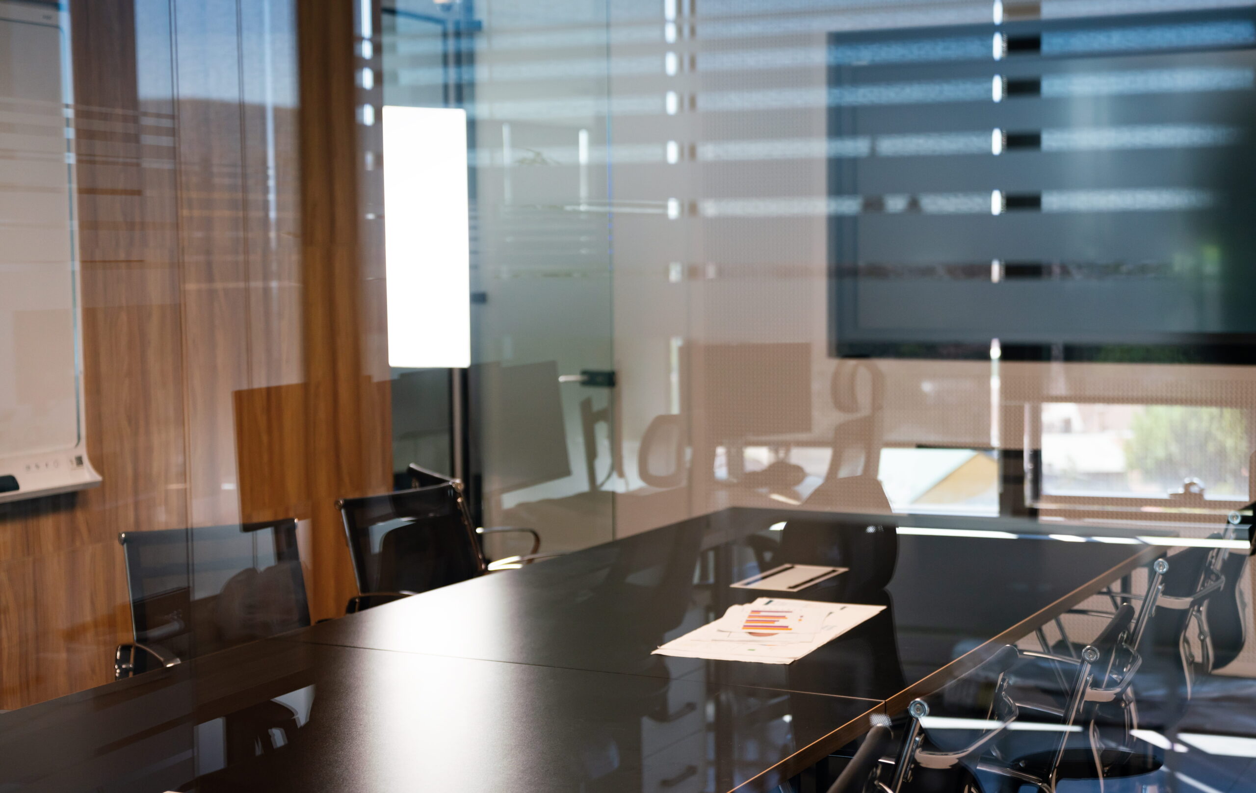 San Diego theft crimes defense attorney consulting clients in a modern conference room with large meeting table
