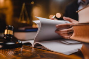 San Diego criminal defense attorney reviewing legal documents beside a judge's gavel while preparing a felony charge reduction defense strategy.